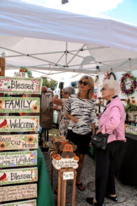 Women looking at arts and crafts displays at the Peach Blossom Festival in Johnston, South Carolina