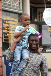 A man and child enjoy the Peach Blossom Festival in Johnston, South Carolina